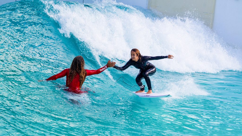 Rob Machado and daughter high-five at the Wavegarden Cove R&D facility in the Basque Country. Photo by 