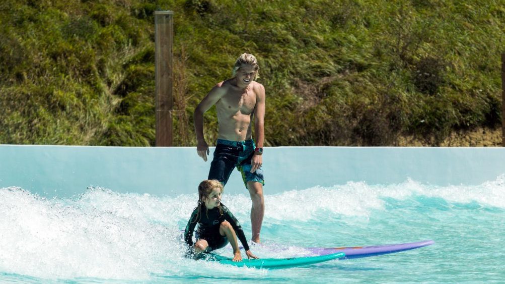 parent and child wave pool surfing