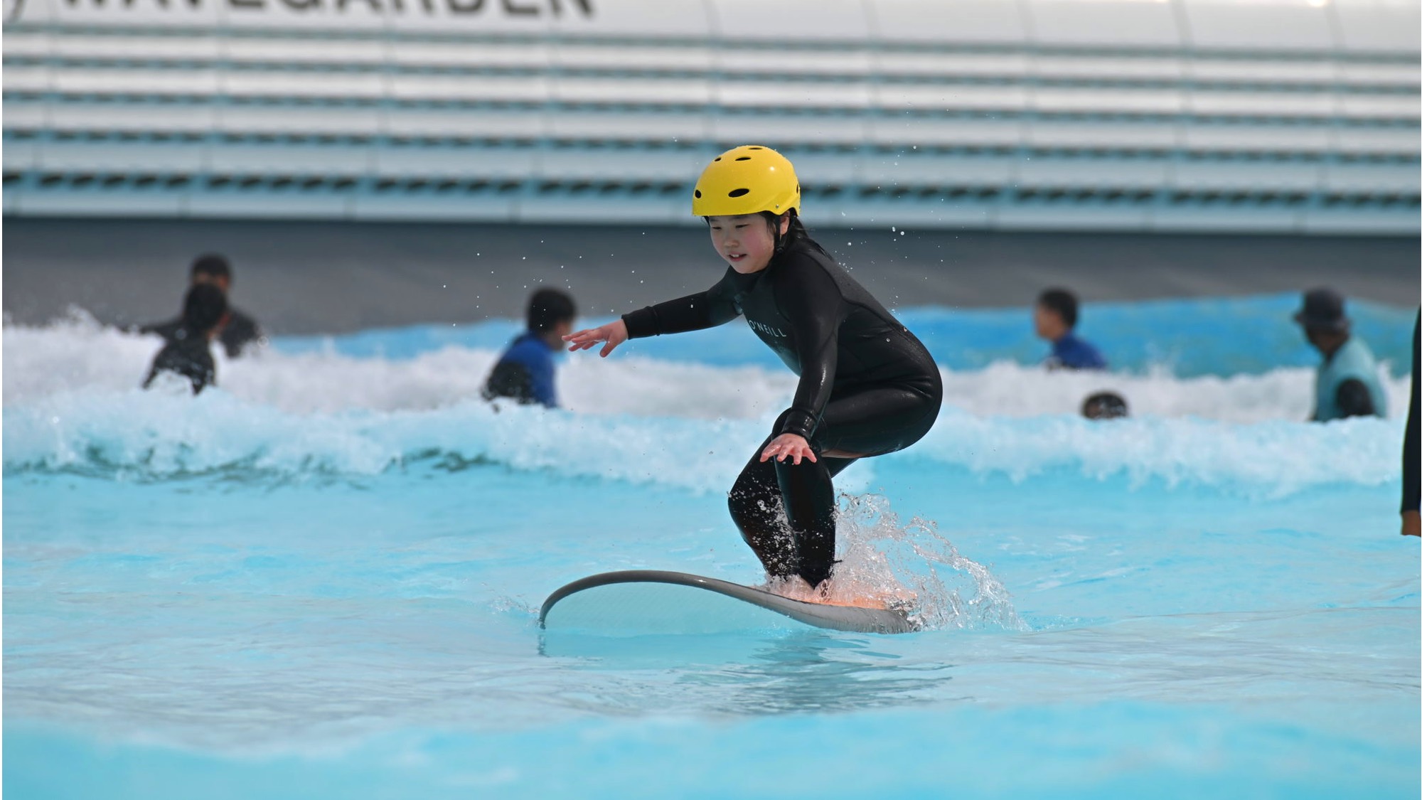 learning to surf at wave park in south korea